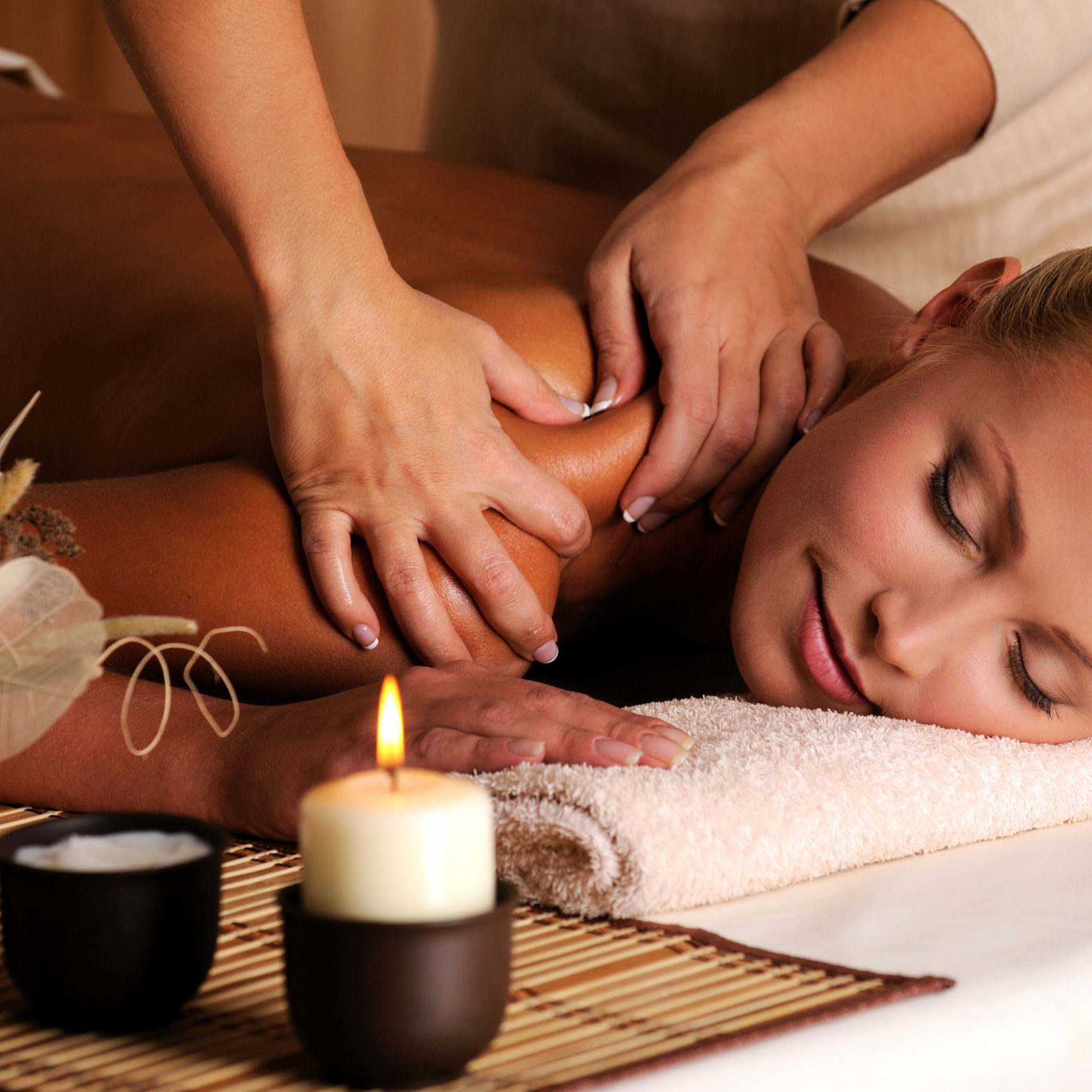 Masseur doing massage on female shoulder in the beauty salon